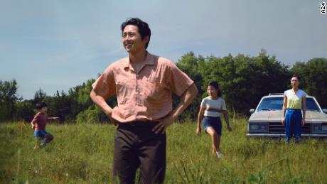 Steven Yeun (center) is shown in a scene from &quot;Minari&quot; with (from left) Alan S. Kim, Noel Cho and Yeri Han.