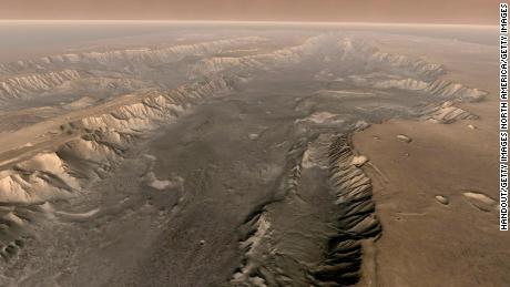 VALLES MARINERIS, MARS  - Mars&#39; own Grand Canyon, Valles Marineris, is shown on the surface of the planet in this composite image made aboard NASA&#39;s Mars Odyssey spacecraft. The image was taken from a video featuring high-resolution images from Arizona State University&#39;s Thermal Emission Imaging System multi-band camera on board the spacecraft. The mosaic was then colored to approximate how Mars would look to the human eye. Valles Marineris is 10 times longer, five times deeper and 20 times wider than Earth&#39;s Grand Canyon.  (Photo by NASA/Arizona State University via Getty Images)