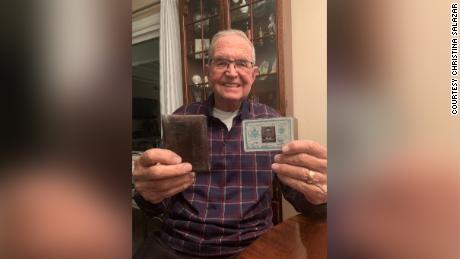 Paul Grisham holds the Navy ID card and the wallet he lost 53-years ago.