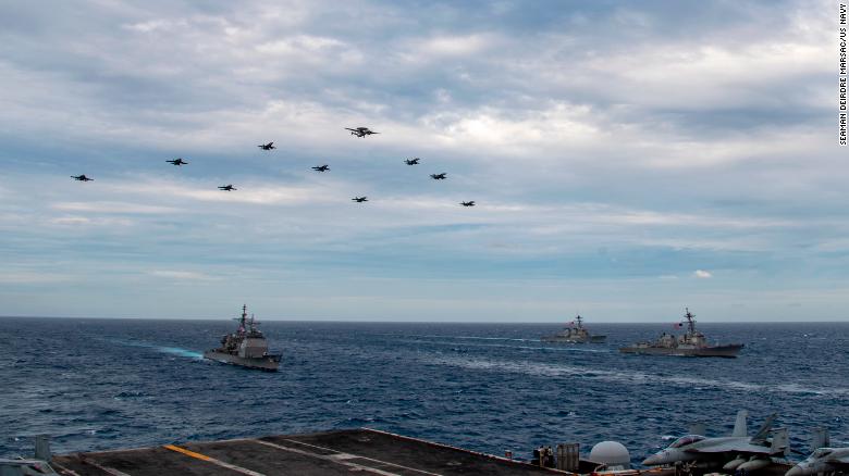 US Navy aircraft fly over the USS Theodore Roosevelt Carrier Strike Group and the USS Nimitz Carrier Strike Group in the South China Sea on February 9, 2021. 