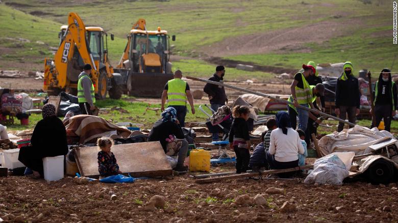 Residents watch Israeli troops demolish tents and other structures in Khirbet Humsa on February 3, 2020. 