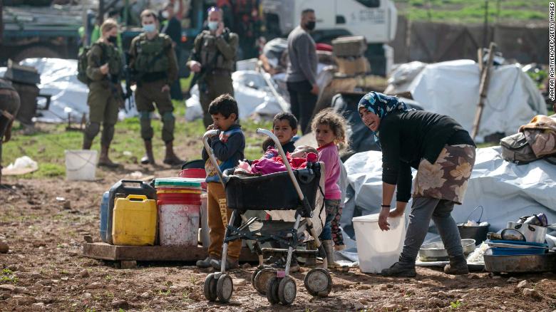 Residents react as Israeli forces demolish tents and structures near Tubas on February 8, 2021. 