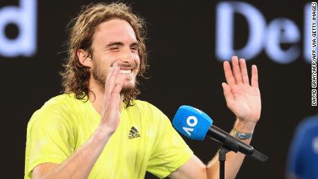 Stefanos Tsitsipas laughs while interviewing. 