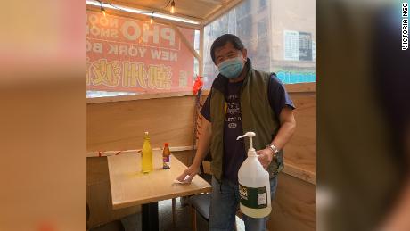 New York City Chinatown restaurant owner Chi Vy Ngo stands in a vestibule outside his &quot;Bo Ky&quot; Chinese and Vietnamese noodle shop on Bayard Street in Manhattan on January 11, 2021.