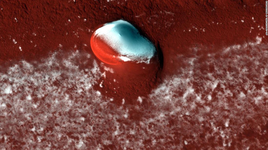 HiRISE captured layered deposits and a bright ice cap at the Martian north pole.