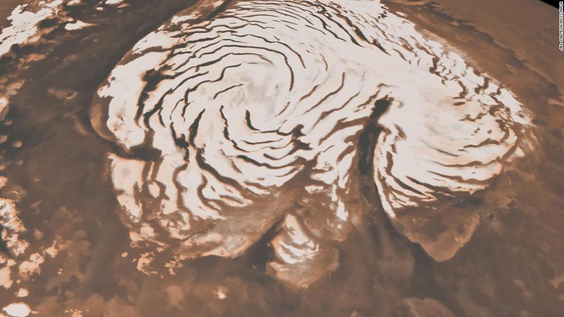 This image, combining data from two instruments aboard NASA&#39;s Mars Global Surveyor, depicts an orbital view of the north polar region of Mars. The ice-rich polar cap is 621 miles across, and the dark bands in are deep troughs. To the right of center, a large canyon, Chasma Boreale, almost bisects the ice cap. Chasma Boreale is about the length of the United States&#39; famous Grand Canyon and up to 1.2 miles deep.