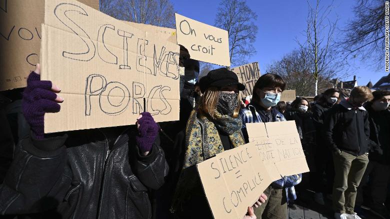 Students demonstrate in front of the Sciences Po university to denounce gender-based violence. Signs read &quot;We believe you&quot; and &quot;Silence = accomplice.&quot;