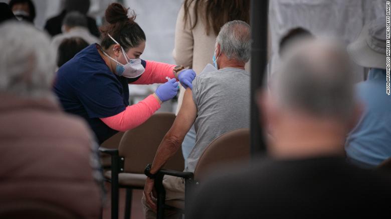A nurse administers a Covid-19 vaccine at Kedren Health on Thursday in Los Angeles.