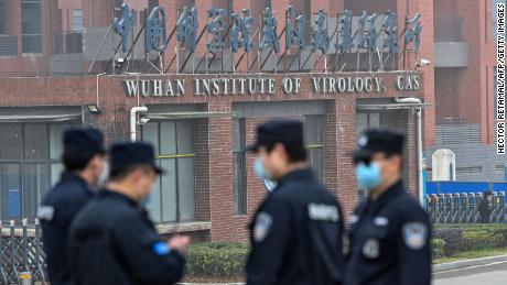 Security personnel stand guard outside the Wuhan Institute of Virology in Wuhan as members of the World Health Organization (WHO) team investigating the origins of the COVID-19 coronavirus make a visit to the institute in Wuhan in China&#39;s central Hubei province on February 3, 2021. (Photo by Hector RETAMAL / AFP) (Photo by HECTOR RETAMAL/AFP via Getty Images)