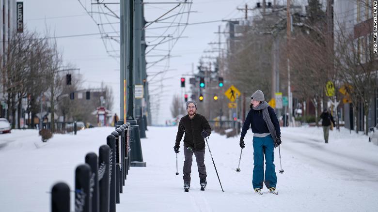 People ski down the Max tracks on North Interstate Avenue in Portland, Oregon, Saturday.