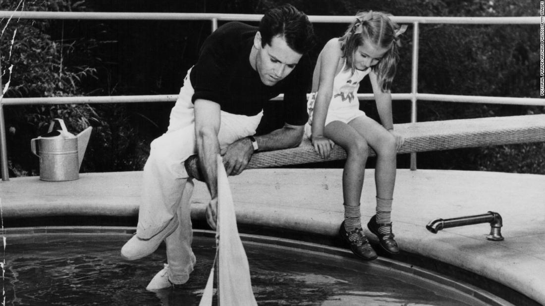 Jane plays with her dad at a swimming pool circa 1945.