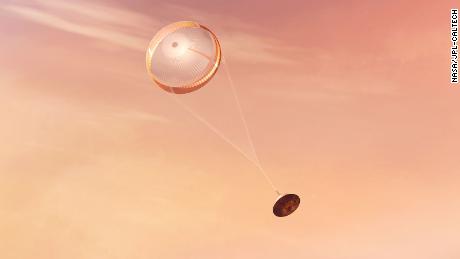 NASAのPerseveranceローバーが着陸する前に、超音速パラシュートを広げているアーティストのイラストです。