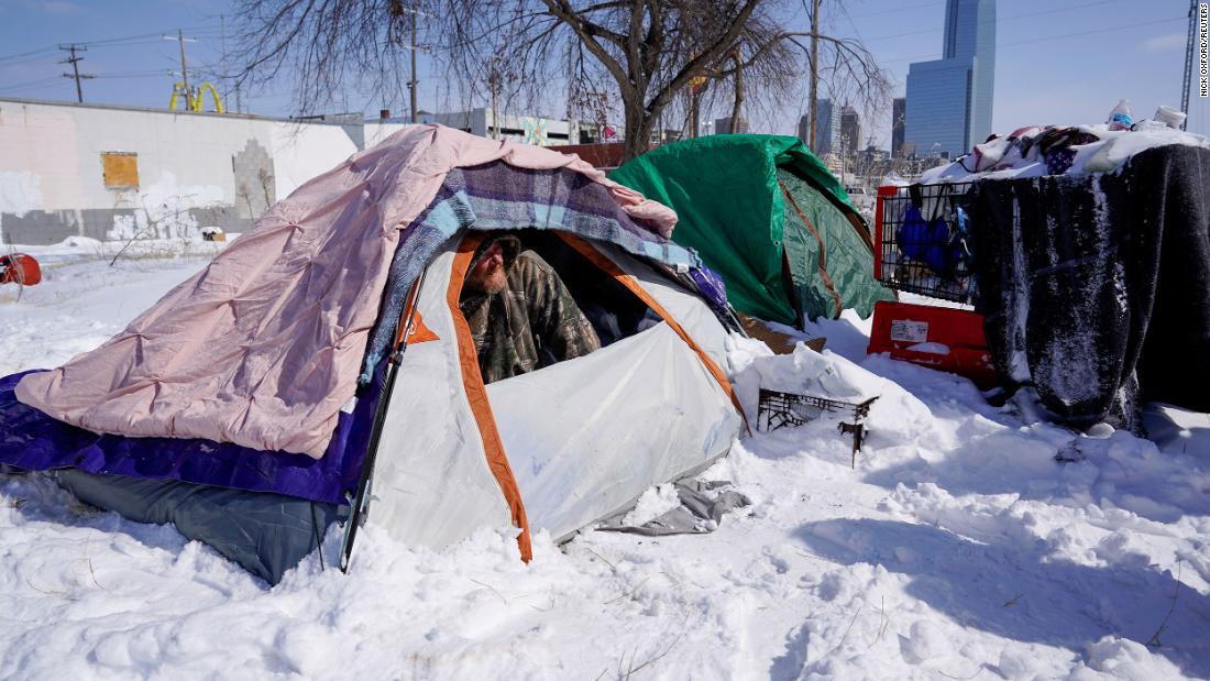 James Derrick, who is homeless, peeks out of his tent in Oklahoma City on Monday. The city had gone a record five days without climbing over 20 degrees, and it wasn&#39;t expected to top that temperature until Thursday.