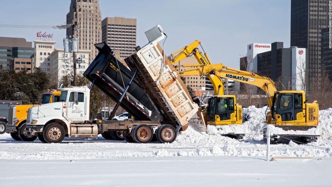 Crews unload snow that they removed from city streets in Oklahoma City.