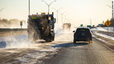 Snow plows clear a lane of I-30, Monday, Feb. 15, 2021, in Dallas. The Nashville Predators and the Dallas Stars NHL hockey game Monday was postponed at the request of Dallas Mayor Eric Johnson due to a shortage of electricity in the region. (AP Photo/Brandon Wade)