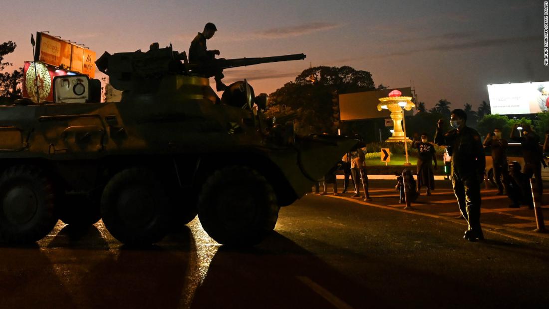 People gather around an armored vehicle in Yangon on February 14.