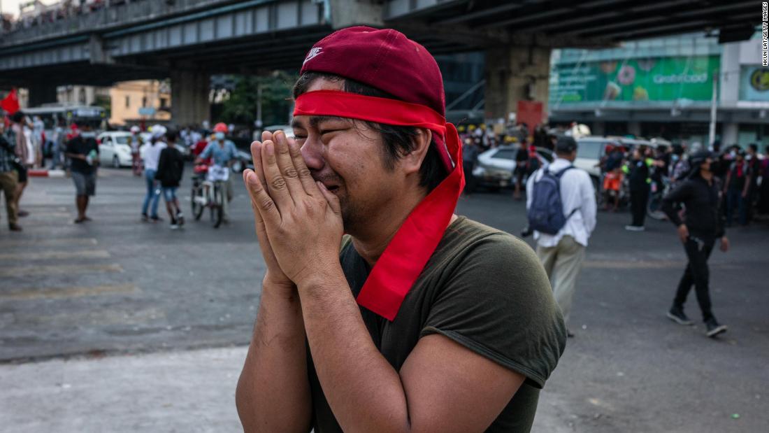 A protester pleads for police to refrain from using tear gas against demonstrators in Yangon on February 9.