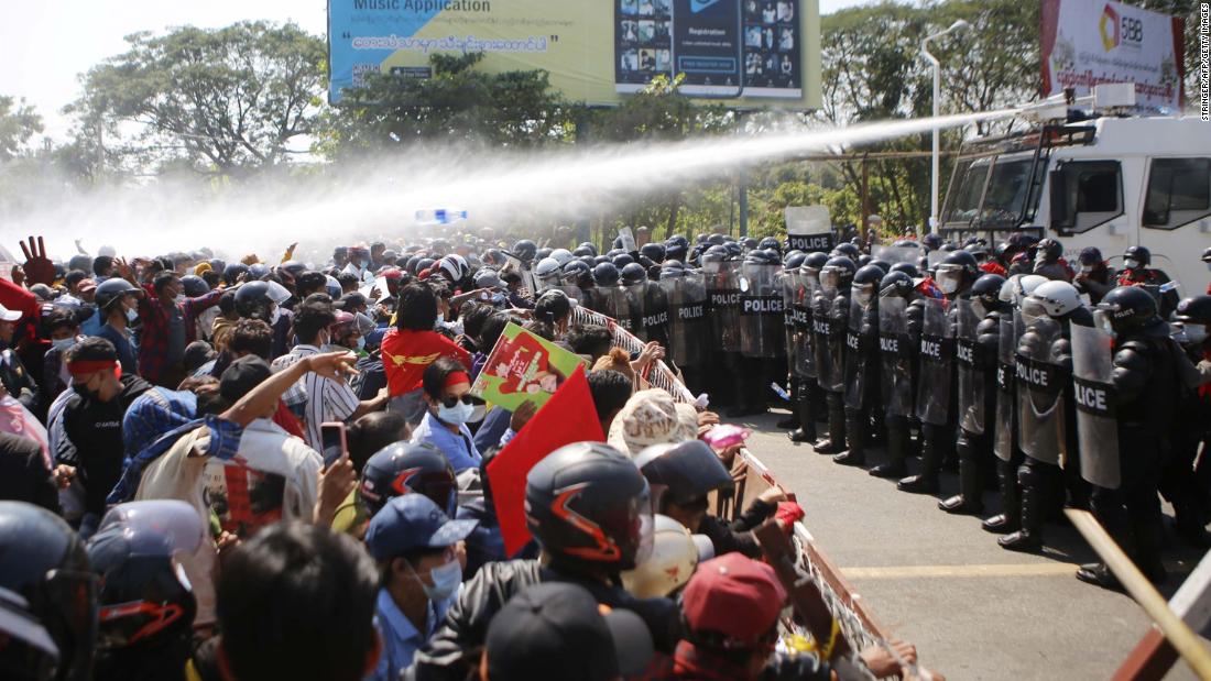 Police fire water cannons at protesters in Naypyidaw on February 9.