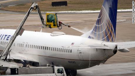 Ice is removed from a plane in Houston.