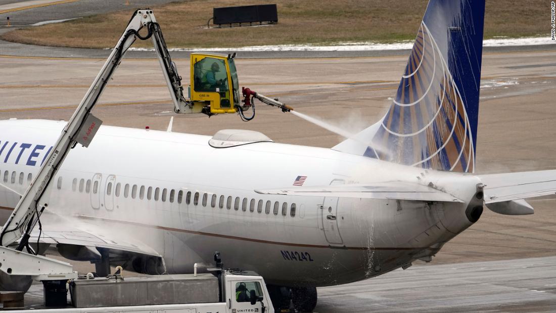 A United Airlines jet is de-iced at the George Bush International Airport in Houston.