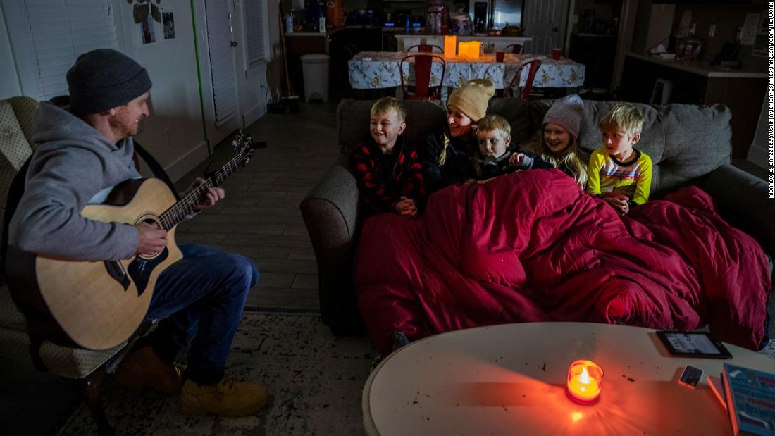 Brett Archibad entertains his family as they try to stay warm in their home in Pflugerville, Texas, on Tuesday.