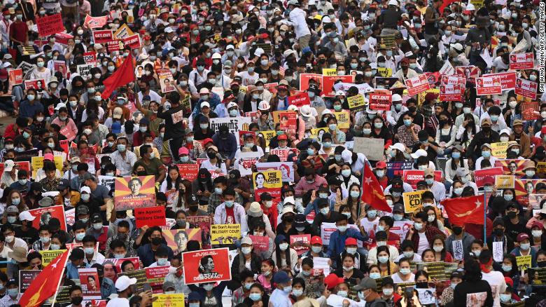 Protesters block a major road during a demonstration in Yangon on February 17.