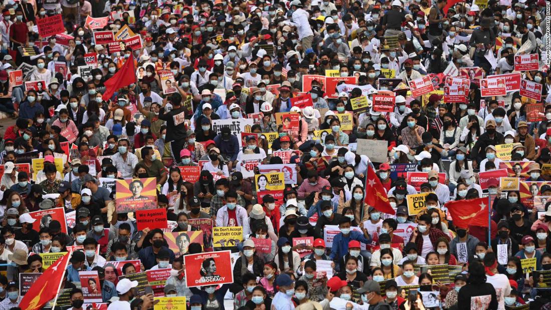 Protesters block a major road during a demonstration in Yangon on February 17.