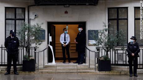 Police stand guard outisde the entrance to King Edward VII hospital in central London where Prince Philip was admitted on Tuesday.