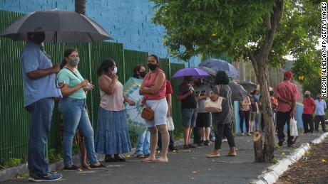 Residents line up to receive the Coronavac vaccine against COVID-19, in Serrana, about 323 km from Sao Paulo, Brazil, on February 17, 2021.