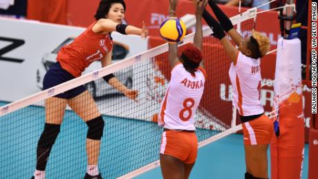 South Korea&#39;s Lee Da-yeong, left, spikes the ball over Kenya&#39;s Trizah Atuka, center, and Jane Wacu Wairimu, right, during a match of the FIVB Women&#39;s World Cup volleyball between South Korea and Kenya in Osaka on September 27, 2019.