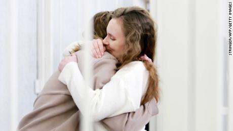 Belsat TV journalists Yekaterina Andreyeva (right) and Darya Chultsova (left)  embrace each other in a defendant&#39;s cage during their trial in Minsk on February 18.