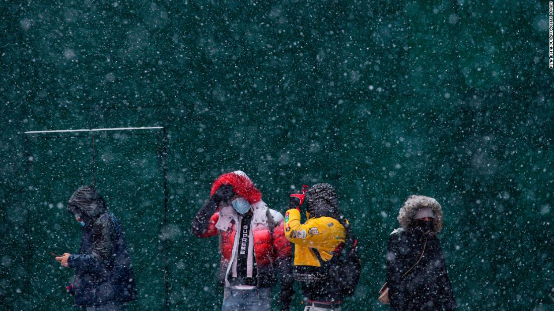Snow falls in New York&#39;s Times Square on Thursday.