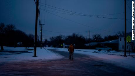 Charles Andrews, 57, walks home through his neighborhood in Waco, Texas as severe winter weather conditions over the last few days has forced road closures and power outages over the state on February 17, 2021. - Millions of people were still without power on February 17 in Texas, the oil and gas capital of the United States, and facing water shortages as an unusual winter storm pummeled the southeastern part of country. The National Weather Service (NWS) issued a winter storm warning for a swathe of the country ranging from east Texas to the East Coast state of Maryland. (Photo by Matthew Busch / AFP) (Photo by MATTHEW BUSCH/AFP via Getty Images)