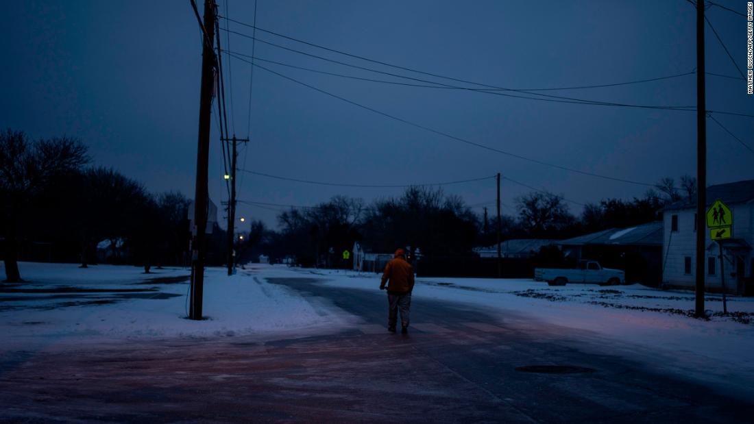 Charles Andrews walks home through his neighborhood in Waco, Texas, on Wednesday. Millions of people were still without power.