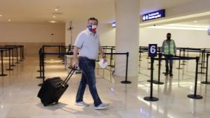 U.S. Senator Ted Cruz (R-TX) carries his luggage at the Cancun International Airport before boarding his plane back to the U.S., in Cancun, Mexico February 18, 2021.