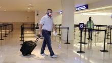 U.S. Senator Ted Cruz (R-TX) carries his luggage at the Cancun International Airport before boarding his plane back to the U.S., in Cancun, Mexico February 18, 2021.