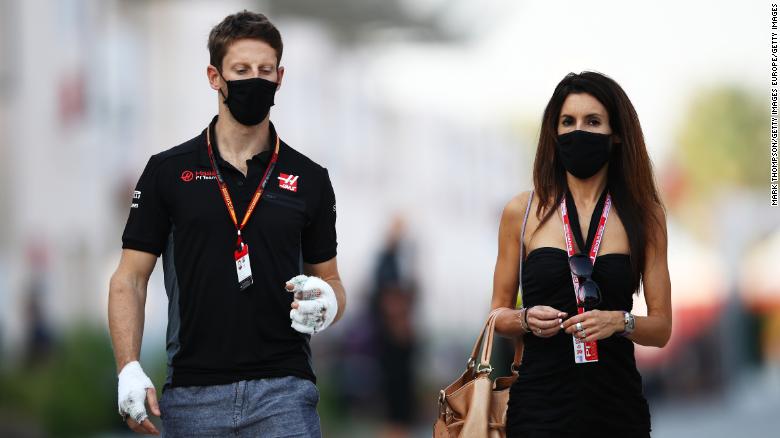 Grosjean and his wife Marion walk in the paddock ahead of the Sakhir Grand Prix in Bahrain.