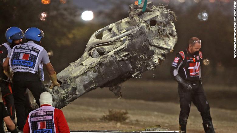 Grosjean&#39;s car is removed from the track following his crash. 