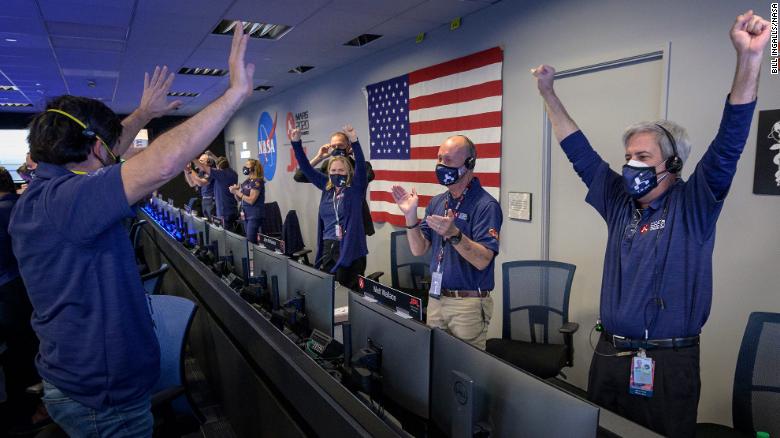 Members of NASA mission control celebrate after receiving confirmation that the Perseverance rover successfully touched down on Mars on Thursday, February 18.