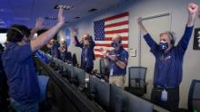 Members of NASA mission control celebrate after receiving confirmation that the Perseverance rover successfully touched down on Mars on Thursday, February 18.