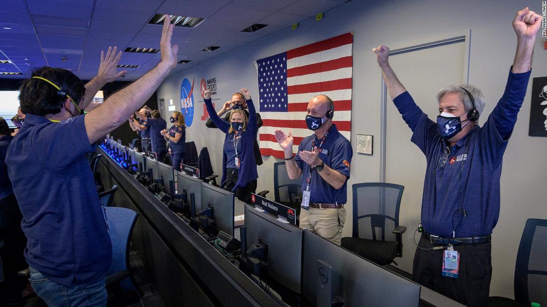 Members of NASA mission control celebrate after receiving confirmation that the rover successfully touched down on Mars on February 18.