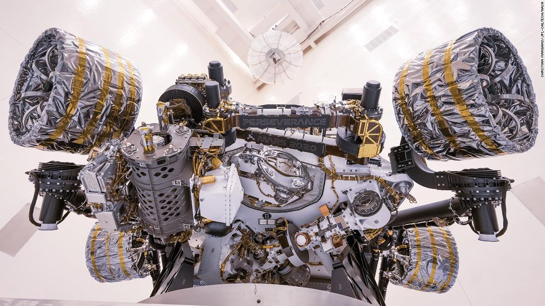 Engineers perform tests on the rover inside the Kennedy Space Center in April 2020. The rover was rotated clockwise and counterclockwise on a spin table to determine its center of gravity. Establishing the rover&#39;s center of gravity helped ensure the spacecraft would land on Mars as calculated.