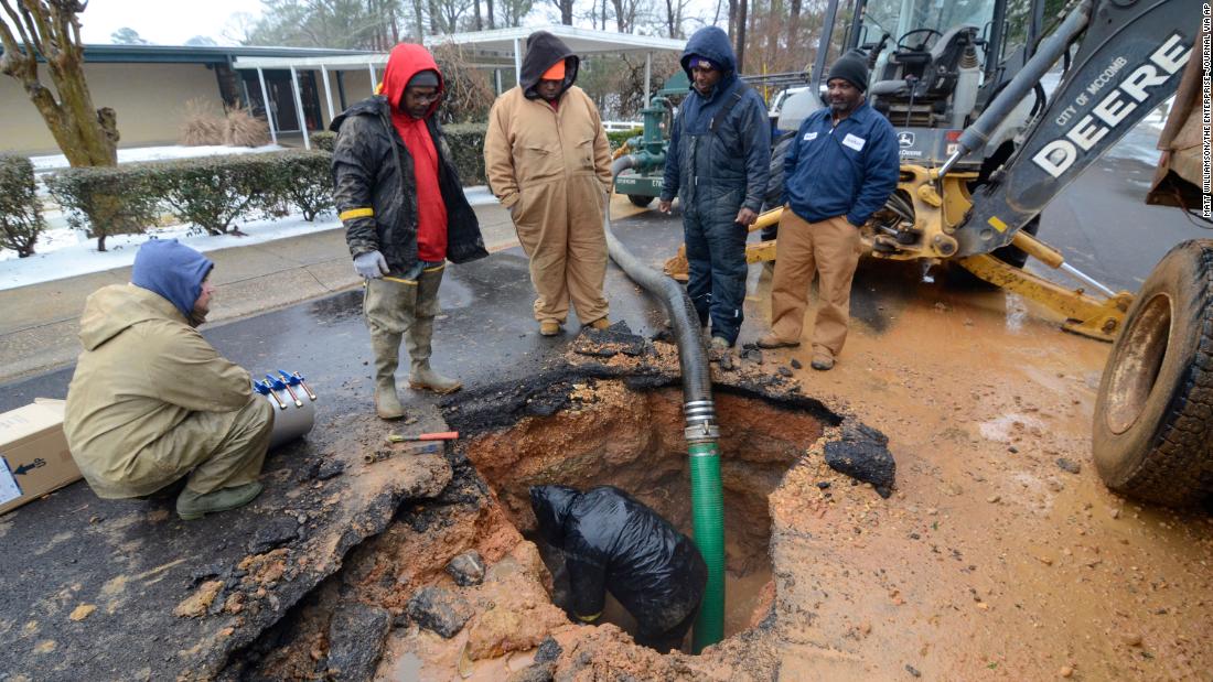 City workers repair a busted water main in McComb, Mississippi, on Thursday.