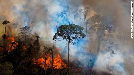 Smoke rises from an illegally lit fire in the Amazon in Brazil&#39;s Pará state in August 2020. Widespread drought and rampant deforestation have scientists concerned that the region could see an extremely damaging fire season this year.
