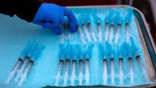 A nurse takes a Moderna Covid-19 vaccines ready to be administered at a vaccination site at Kedren Community Health Center, in South Central Los Angeles, California on February 16, 2021. 