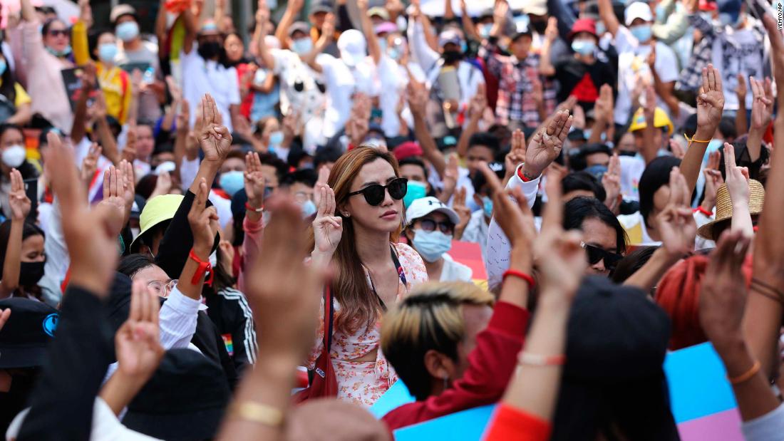 Protesters flash the three-fingered salute during a rally in downtown Yangon on February 19.
