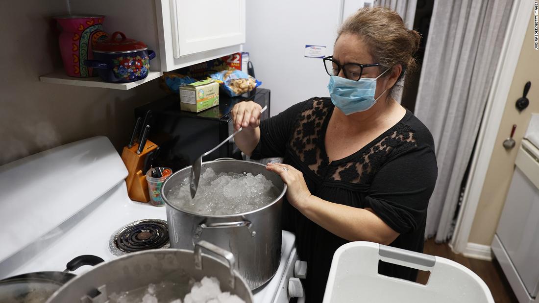 Marie Maybou melts snow on the kitchen stove on February 19 in Austin. Ms. Maybou was using the water to flush the toilets in her home after the city water stopped running. 