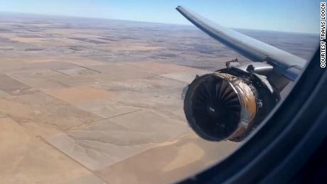 Passenger Travis Loock hears a loud surge, looks out his window and clips this photo of the damaged engine on United Flight 328.