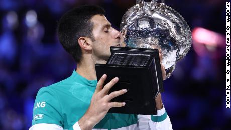 MELBOURNE, AUSTRALIA - FEBRUARY 21: Novak Djokovic of Serbia holds the Norman Brookes Challenge Cup as he celebrates victory in his Men&#39;s Singles Final match against Daniil Medvedev of Russia  during day 14 of the 2021 Australian Open at Melbourne Park on February 21, 2021 in Melbourne, Australia. (Photo by Cameron Spencer/Getty Images)