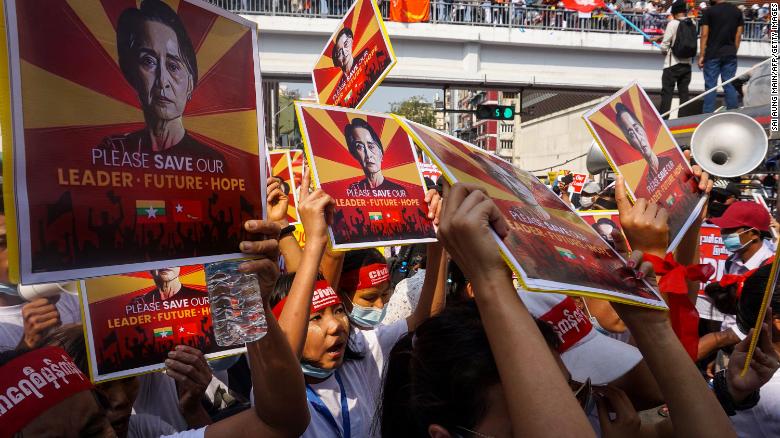 Protesters hold signs featuring Aung San Suu Kyi as they take part in a demonstration against the military coup in Yangon on February 22. 